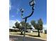 Street view featuring well-maintained landscaping, mature trees, and community lighting for evening ambiance at 225 N Standage -- # 139, Mesa, AZ 85201