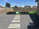 Landscaped backyard features a refreshing pool, artificial turf, gravel accents, and lounge seating at 23644 S 209Th Pl, Queen Creek, AZ 85142