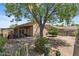 A private backyard featuring a covered patio and desert landscaping at 2467 E Winchester Pl, Chandler, AZ 85286