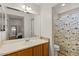 Bathroom with a single vanity, large mirror, and tub/shower combination at 2467 E Winchester Pl, Chandler, AZ 85286
