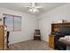 A cozy bedroom with a desk, chair, and window providing natural light, carpet flooring at 2467 E Winchester Pl, Chandler, AZ 85286