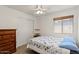 Comfortable bedroom with a ceiling fan, large closet, and a charming dresser at 2467 E Winchester Pl, Chandler, AZ 85286
