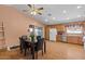 Dining area with a dark wood table, laminate flooring and kitchen access at 2467 E Winchester Pl, Chandler, AZ 85286