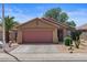 Single-story house with a two-car garage, desert landscaping, and concrete driveway at 2467 E Winchester Pl, Chandler, AZ 85286