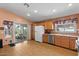 Bright kitchen with wood cabinets, stainless steel appliances, and sliding glass door to backyard at 2467 E Winchester Pl, Chandler, AZ 85286
