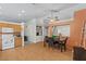 Open kitchen with laminate floors, white appliances, and a dining table at 2467 E Winchester Pl, Chandler, AZ 85286