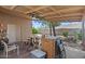Spacious covered patio with outdoor seating and views of the landscaped backyard, perfect for entertaining at 2467 E Winchester Pl, Chandler, AZ 85286