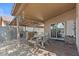 Covered patio featuring a built-in bar area, seating, and a sliding glass door to the interior at 2467 E Winchester Pl, Chandler, AZ 85286