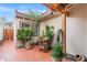 Inviting courtyard with brick tiling, potted plants, and a charming pergola adorned with string lights at 2528 N 22Nd Dr, Phoenix, AZ 85009