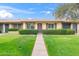 Inviting front yard with lush green grass, trimmed hedges, and a walkway leading to the front door at 2528 N 22Nd Dr, Phoenix, AZ 85009