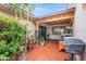 Relaxing outdoor patio featuring brick tiling, lush plants, and a covered area for comfortable entertaining at 2528 N 22Nd Dr, Phoenix, AZ 85009