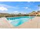 Refreshing community swimming pool surrounded by well-maintained landscaping and a clear blue sky at 2528 N 22Nd Dr, Phoenix, AZ 85009