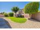 A private backyard has a grassy area and is surrounded by mature landscaping and a brick wall at 25860 N 47Th Pl, Phoenix, AZ 85050