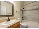 Bathroom with a single vanity, a framed mirror and a shower-tub combo with neutral tile at 25860 N 47Th Pl, Phoenix, AZ 85050