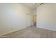 Bedroom featuring neutral carpet, a closet and white doors, flooded with natural light at 25860 N 47Th Pl, Phoenix, AZ 85050