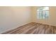 Bedroom with wood-look tile floors, a window with a view and fresh paint at 25860 N 47Th Pl, Phoenix, AZ 85050