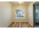 Bedroom with sliding glass doors, neutral paint, wood look tile floor and large window with blinds at 25860 N 47Th Pl, Phoenix, AZ 85050