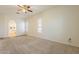 Spacious bedroom with carpet, windows with blinds, and arched entrance to an ensuite bathroom at 25860 N 47Th Pl, Phoenix, AZ 85050
