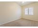 Cozy bedroom with neutral carpet, a window and a ceiling fan, ready for relaxation at 25860 N 47Th Pl, Phoenix, AZ 85050