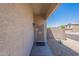 Covered front entrance featuring a security screen door and low-maintenance landscaping at 25860 N 47Th Pl, Phoenix, AZ 85050
