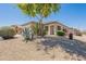 Charming home exterior with desert landscaping and a mature shade tree at 25860 N 47Th Pl, Phoenix, AZ 85050