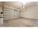 A spacious two car garage has painted floors, an automatic door and added storage above the door at 25860 N 47Th Pl, Phoenix, AZ 85050