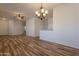 Spacious living area with elegant chandelier and easy access to kitchen and laundry at 25860 N 47Th Pl, Phoenix, AZ 85050