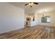 Open-concept living area with stylish flooring and a view into the kitchen at 25860 N 47Th Pl, Phoenix, AZ 85050