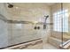 Close up of the glass enclosed shower with dual shower heads and bench seating at 25860 N 47Th Pl, Phoenix, AZ 85050
