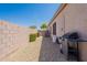 A low maintenance side yard has a BBQ, storage, and privacy wall at 25860 N 47Th Pl, Phoenix, AZ 85050