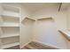A walk-in closet with built-in shelving and wood-look plank flooring at 25860 N 47Th Pl, Phoenix, AZ 85050