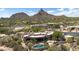 Expansive desert home showcasing backyard pool, patio, and mountain views at 26049 N 104Th Pl, Scottsdale, AZ 85255
