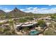 Desert home displaying its backyard pool, patio and desert landscape, with mountain views at 26049 N 104Th Pl, Scottsdale, AZ 85255