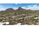 Community aerial view showing homes, a golf course, desert vegetation, and mountain views at 26049 N 104Th Pl, Scottsdale, AZ 85255