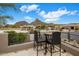 Charming balcony with seating offering picturesque views of the surrounding desert landscape and distant mountains at 26049 N 104Th Pl, Scottsdale, AZ 85255