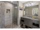Modern bathroom with a glass shower featuring decorative tile and a vanity with gray cabinetry and stone counters at 26049 N 104Th Pl, Scottsdale, AZ 85255