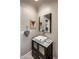 Bathroom featuring a vessel sink vanity, modern fixtures, and a square mirror at 26049 N 104Th Pl, Scottsdale, AZ 85255