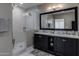 Modern bathroom featuring double sinks, a walk-in shower, and sleek finishes at 26049 N 104Th Pl, Scottsdale, AZ 85255