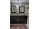 Bathroom vanity with double sinks, modern fixtures and a decorative rug at 26049 N 104Th Pl, Scottsdale, AZ 85255