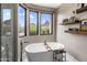 Spa-like bathroom with freestanding tub, mountain views, and floating shelves at 26049 N 104Th Pl, Scottsdale, AZ 85255