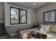 Cozy bedroom featuring a window with shutters and a view of the outdoors at 26049 N 104Th Pl, Scottsdale, AZ 85255