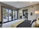 Bright bedroom with a kitchenette, large windows, and access to the outdoor patio at 26049 N 104Th Pl, Scottsdale, AZ 85255