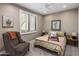 Neutral bedroom with plantation shutters, ceiling fan, and patterned accent chair at 26049 N 104Th Pl, Scottsdale, AZ 85255