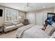 Bright bedroom with plantation shutters, plush seating, and modern arcade game at 26049 N 104Th Pl, Scottsdale, AZ 85255