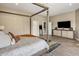 Bright bedroom features a modern bed frame and a TV console at 26049 N 104Th Pl, Scottsdale, AZ 85255