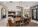 Open floor plan combining the kitchen and dining room with a custom light fixture and modern decor at 26049 N 104Th Pl, Scottsdale, AZ 85255
