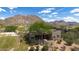Desert home exterior displaying desert landscaping, private gated entry and mountain views at 26049 N 104Th Pl, Scottsdale, AZ 85255