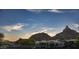 Desert property featuring mountain views in the background at sunset at 26049 N 104Th Pl, Scottsdale, AZ 85255