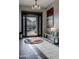 Elegant foyer featuring a modern chandelier, a striking piece of art, and views of the landscaped yard at 26049 N 104Th Pl, Scottsdale, AZ 85255