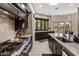 Gourmet kitchen with stainless steel stove and oven and large picture window overlooking the property at 26049 N 104Th Pl, Scottsdale, AZ 85255